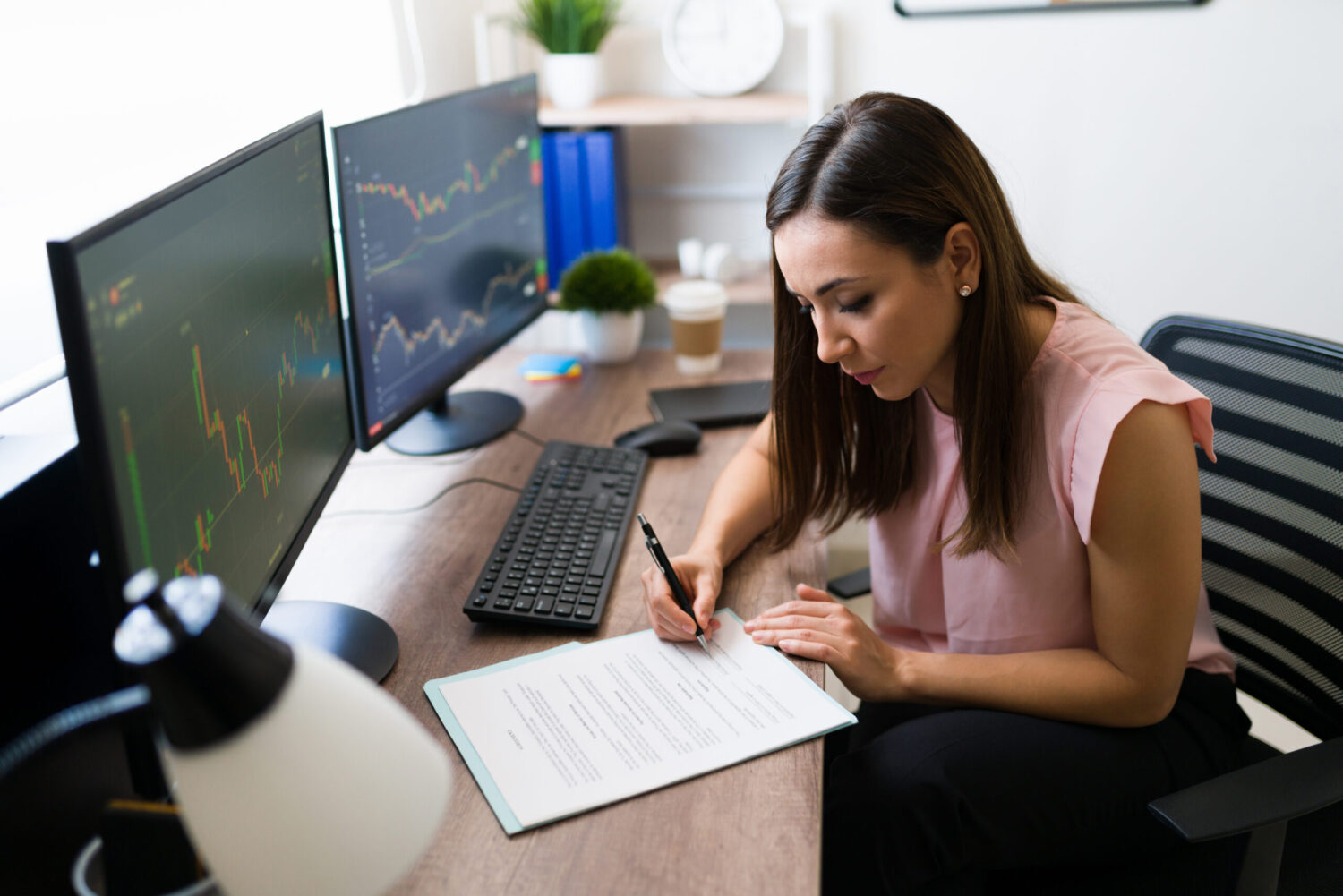 Young woman checking work papers at home